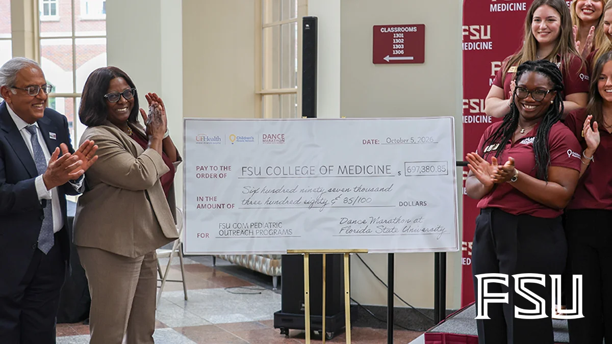 College of Medicine Dean Alma Littles, second from left, with Dance Marathon at FSU student leaders and this year's check at the college.