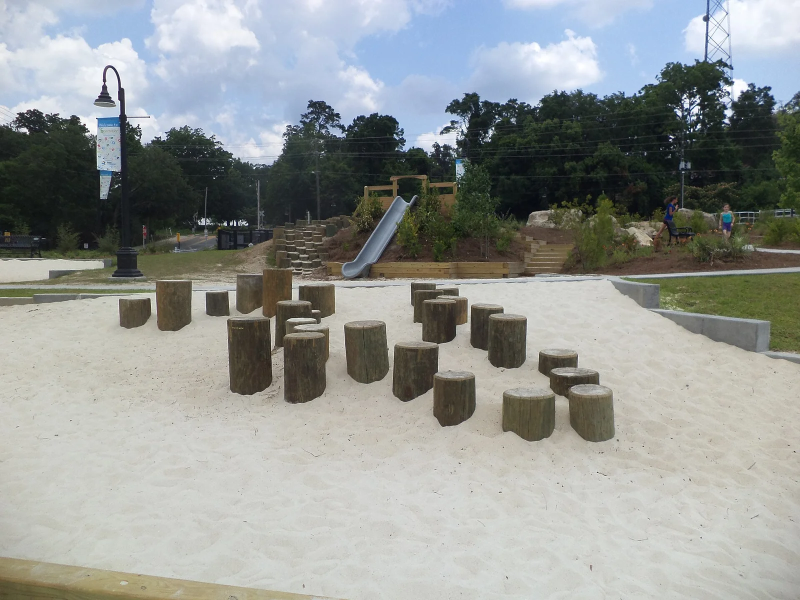 Log steps, a sand area and the slide at the Discovery play area in Cascades Park, downtown Tallahassee.